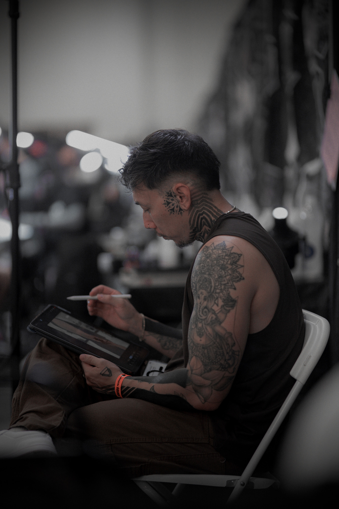 David VanCasso sketching a custom tattoo design on an iPad