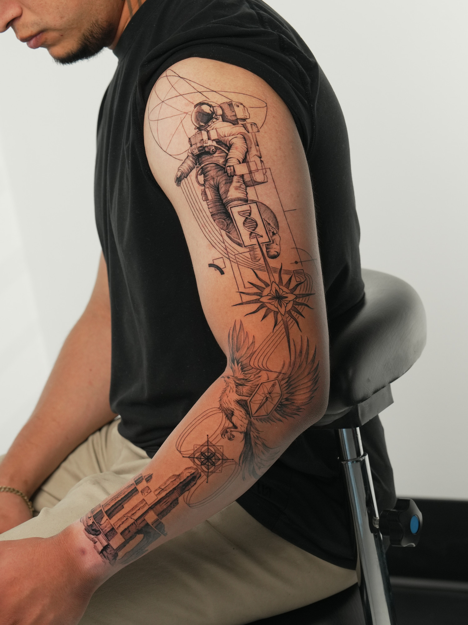 Astronaut and sacred geometry sleeve tattoo